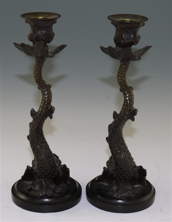 A pair of 19th century bronze candlesticks, modelled as dolphins, 10.5in.
